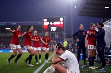 Spain players celebrate while England players look dejected after a dominant win